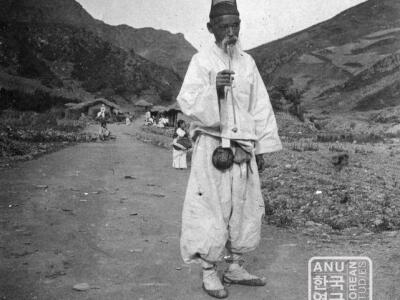 Old man with pipe on road