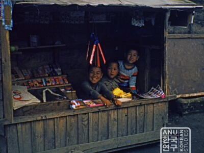 Kids selling candy and toys from cart, 1950s